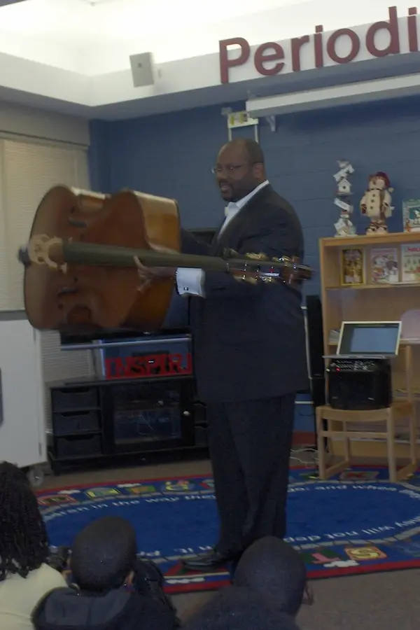 John-Brown-Teaching John Brown writing a note down at his desk.